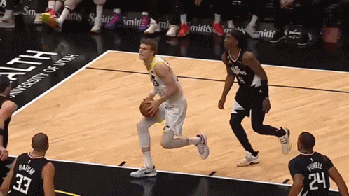 A Basketball Game Is Being Played In Front Of A University Of Utah Banner GIF