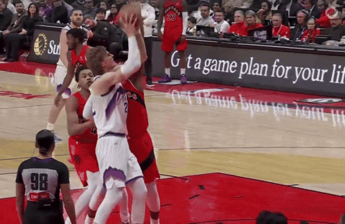 a basketball game is being played in front of an advertisement for a game plan for your life