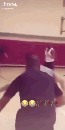 a basketball game is being played on a court and a man is crying .