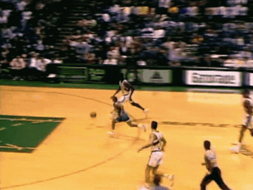 A Basketball Game Is Being Played On A Court That Has A Sign That Says ' Reebok ' On It GIF