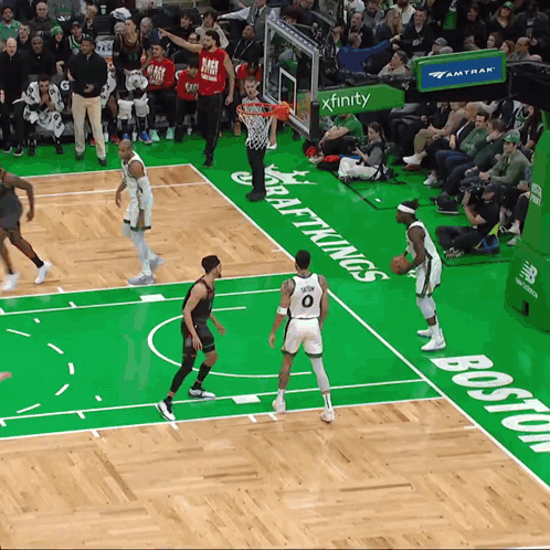 A Basketball Game Is Being Played On A Court That Has The Word Boston Written On It GIF
