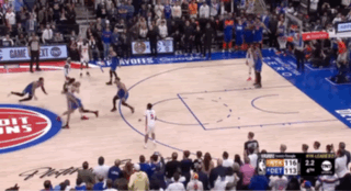 a basketball game is being played on a court that has the word detroit on the floor