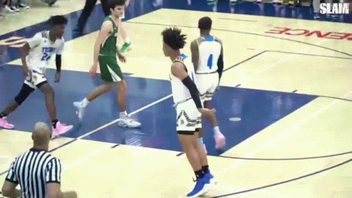 A Basketball Game Is Being Played On A Court That Says Slam GIF