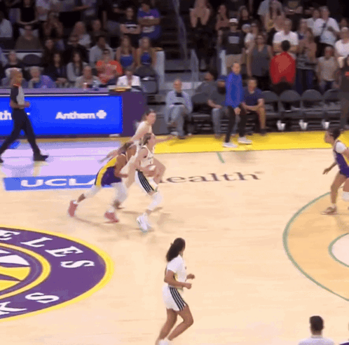 A Basketball Game Is Being Played On A Court That Says Ucla On It GIF