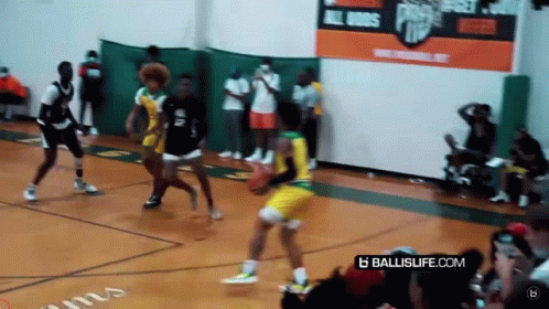 A Basketball Game Is Being Played On A Court With A Banner That Says Ballislife.com . GIF