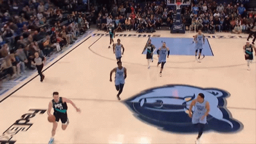 A Basketball Game Is Being Played On A Court With A Bear Logo In The Background GIF