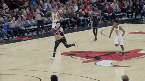 A Basketball Game Is Being Played On A Court With A Bull On The Court GIF