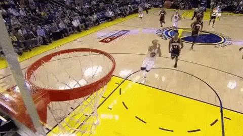 A Basketball Game Is Being Played On A Court With A Crowd In The Stands Watching . GIF