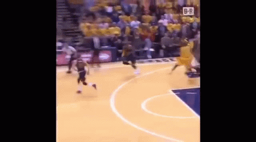 A Basketball Game Is Being Played On A Court With A Crowd In The Stands Watching . GIF