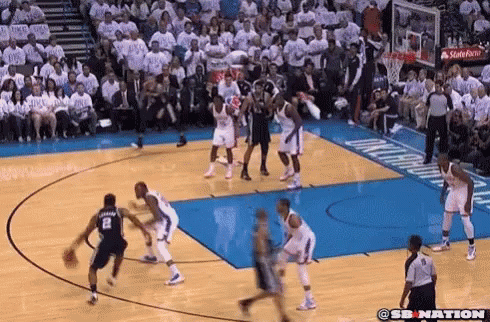 A Basketball Game Is Being Played On A Court With A Crowd In The Stands Watching . GIF