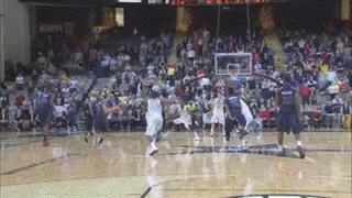 A Basketball Game Is Being Played On A Court With A Crowd Watching GIF