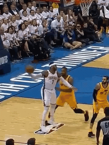 A Basketball Game Is Being Played On A Court With A Crowd Watching . GIF