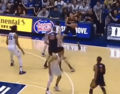 a basketball game is being played on a court with a jersey miller ad in the background