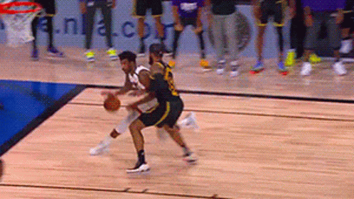 A Basketball Game Is Being Played On A Court With A Nba.com Banner In The Background GIF