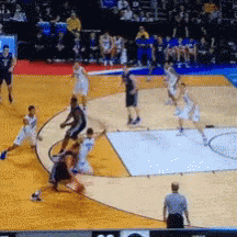 a basketball game is being played on a court with a referee watching