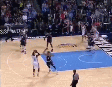 A Basketball Game Is Being Played On A Court With A Referee . GIF