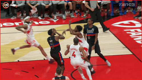a basketball game is being played on a court with a sign that says fan on it