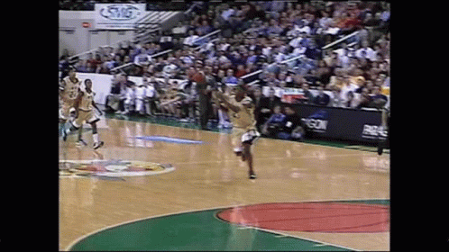 A Basketball Game Is Being Played On A Court With A Sign That Says Swg GIF