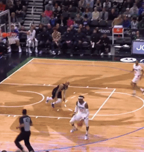 A Basketball Game Is Being Played On A Court With A Sign That Says Verizon On It GIF