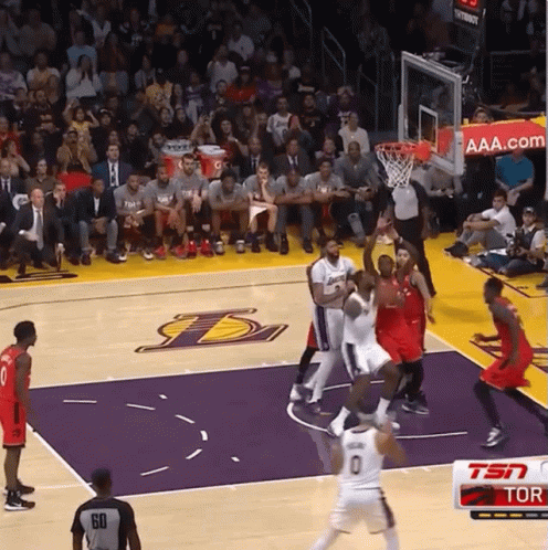 A Basketball Game Is Being Played On A Court With The Lakers Logo GIF