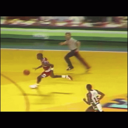 A Basketball Game Is Being Played With A Referee Watching GIF