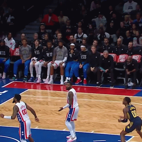 A Basketball Game Is Underway And The Nets Are Sitting In The Stands Watching GIF