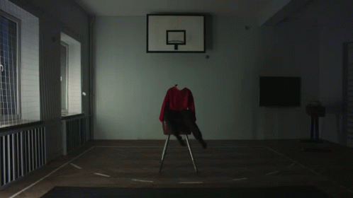 A Basketball Hoop With A Red Shirt On A Chair In Front Of It GIF