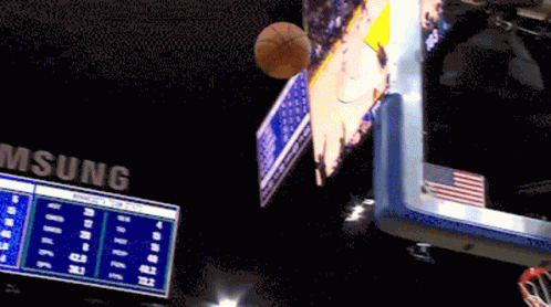 A Basketball Is Flying Through The Air In Front Of A Scoreboard That Says Samsung GIF