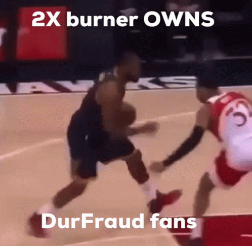 a basketball player dribbles the ball while another player tries to stop him