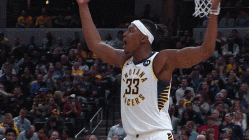 A Basketball Player For The Indiana Pacers Celebrates With His Arms In The Air GIF