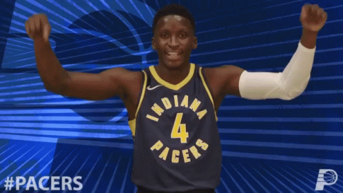 A Basketball Player For The Indiana Pacers Celebrates With His Fist In The Air GIF