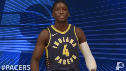 A Basketball Player For The Indiana Pacers Flexes His Arms GIF