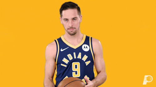 A Basketball Player For The Indiana Pacers Holds A Basketball GIF