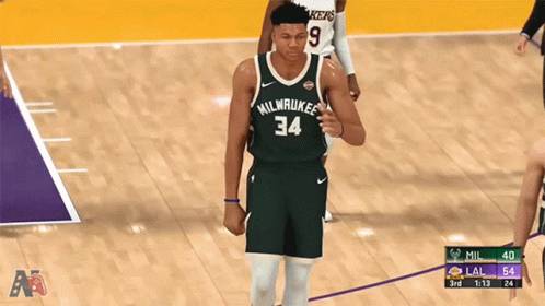 A Basketball Player For The Milwaukee Bucks Is Walking On The Court GIF