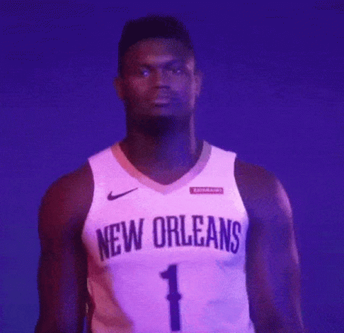 A Basketball Player For The New Orleans Is Standing In Front Of A Purple Background GIF