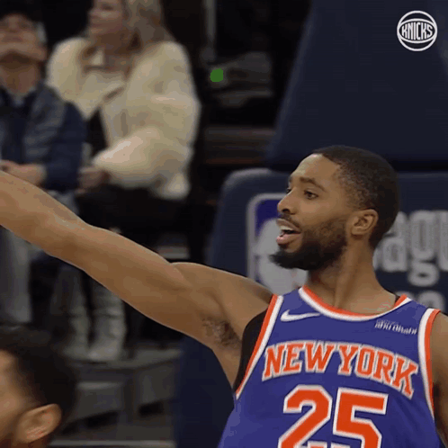A Basketball Player For The New York Knicks Reaches Up GIF