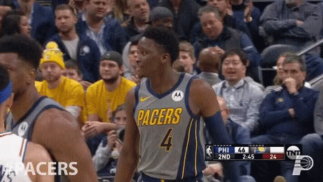 A Basketball Player For The Pacers Is Standing In Front Of A Crowd GIF
