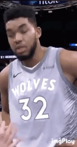 A Basketball Player For The Wolves Is Wearing A Blue Jersey With The Number 32 On It . GIF