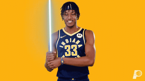 A Basketball Player From The Indiana Pacers Holds A Light Saber GIF
