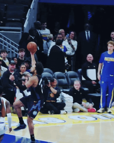 A Basketball Player Holds Up A Basketball In Front Of A Crowd With The Word Pacers On His Shirt GIF