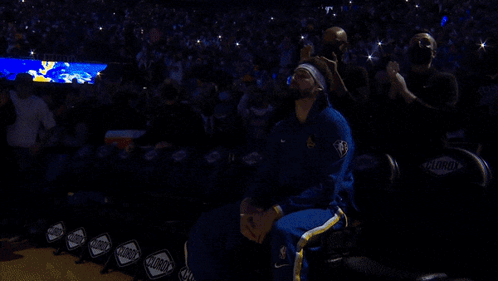 A Basketball Player In A Blue And Gold Uniform Stands On The Court GIF