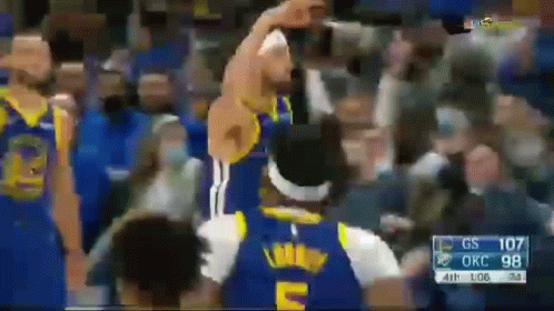 A Basketball Player In A Blue Jersey With The Letter E On It Is Standing In Front Of A Crowd . GIF