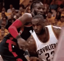 A Basketball Player In A Cavaliers Jersey Is Fighting Another Player . GIF