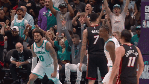 A Basketball Player In A Charlotte Jersey Stands In Front Of The Crowd GIF
