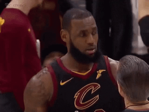 A Basketball Player In A Cleveland Cavaliers Jersey Is Talking To Another Player . GIF