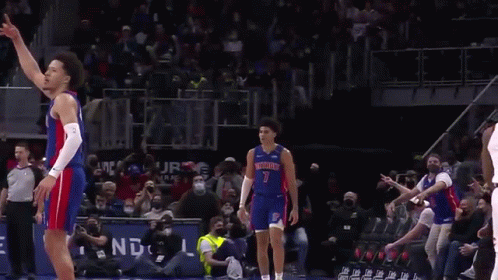 A Basketball Player In A Detroit Jersey Is Standing On The Court . GIF