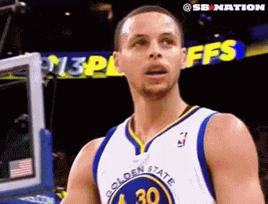 A Basketball Player In A Golden State Warriors Jersey Is Standing In Front Of A Basketball Net . GIF