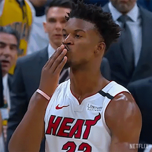 A Basketball Player In A Heat Jersey Is Blowing A Kiss . GIF