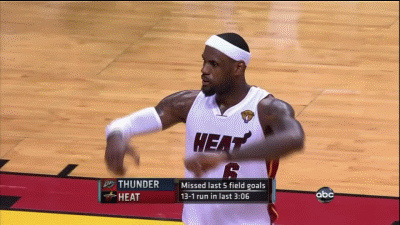 A Basketball Player In A Heat Uniform Is Dancing On The Court GIF