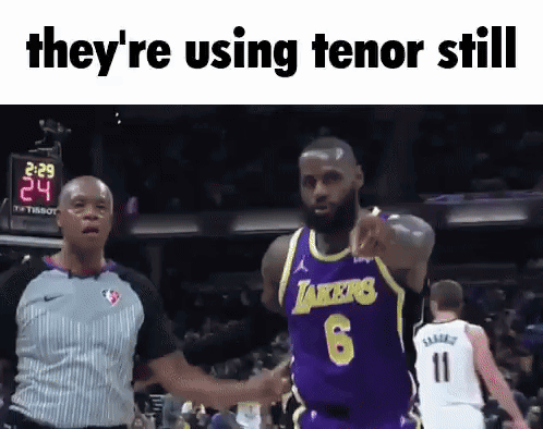 A Basketball Player In A Lakers Jersey Is Pointing At A Referee GIF
